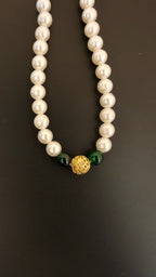 Pearls mala with a golden filigree pendant with green glass beads for a baby boy
