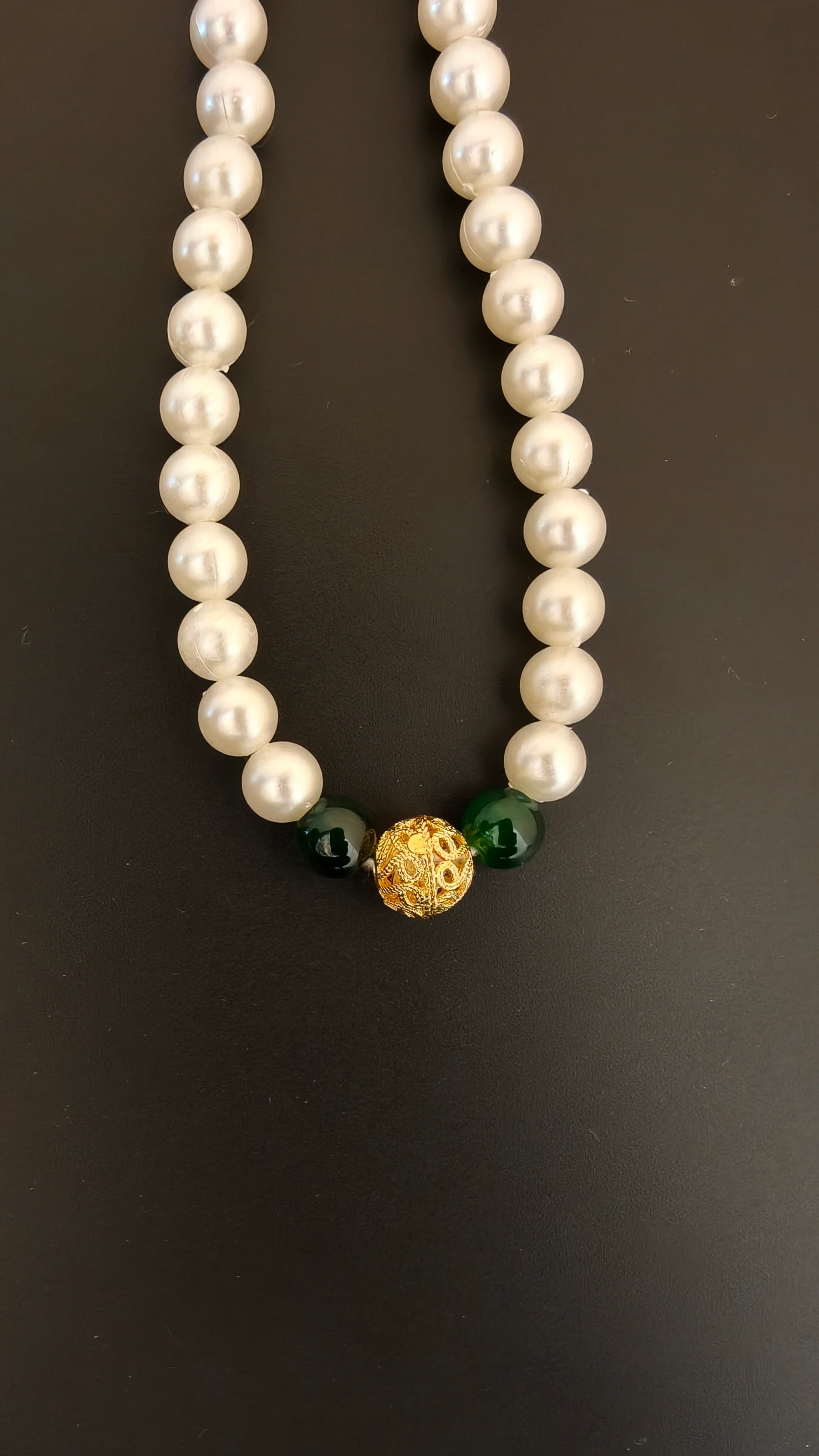 Pearls mala with a golden filigree pendant with green glass beads for a baby boy