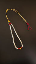 Pearls mala with a golden filigree pendant with red glass beads for a baby boy