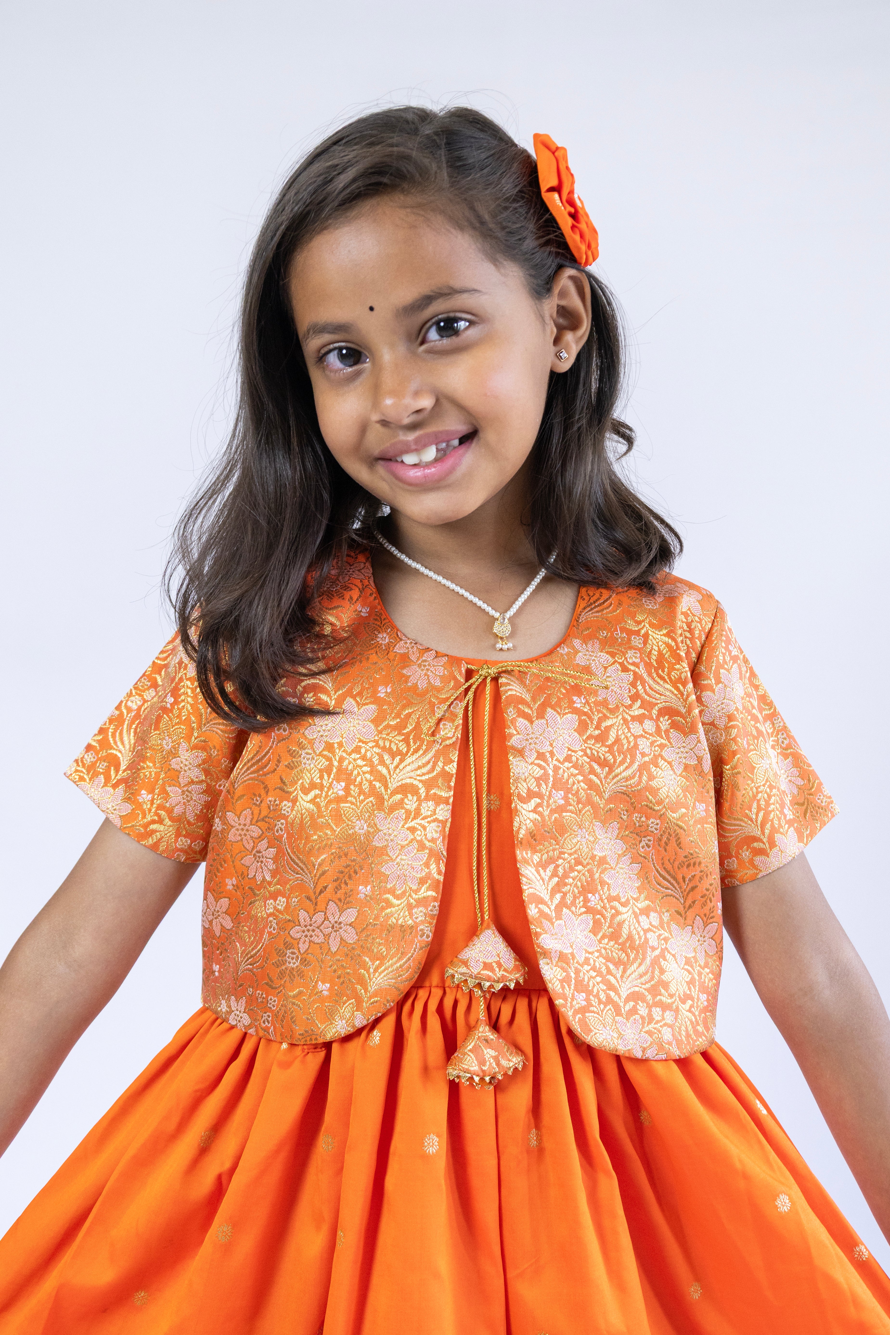 Orange soft banaras brocade silk frock / dress with light orange premium banaras brocade border and a removable jacket for girls