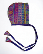 Multi Colored-Purple Banarasi Brocade Silk Baby Bonnet.Golden brocade bonnet,paithani booties,fabric headbands all these Handcrafted accessories for Newborn are perfect add ons to any traditional attire of the baby.Designer baby mats,set of generic bloomers are other naming ceremony essentials.