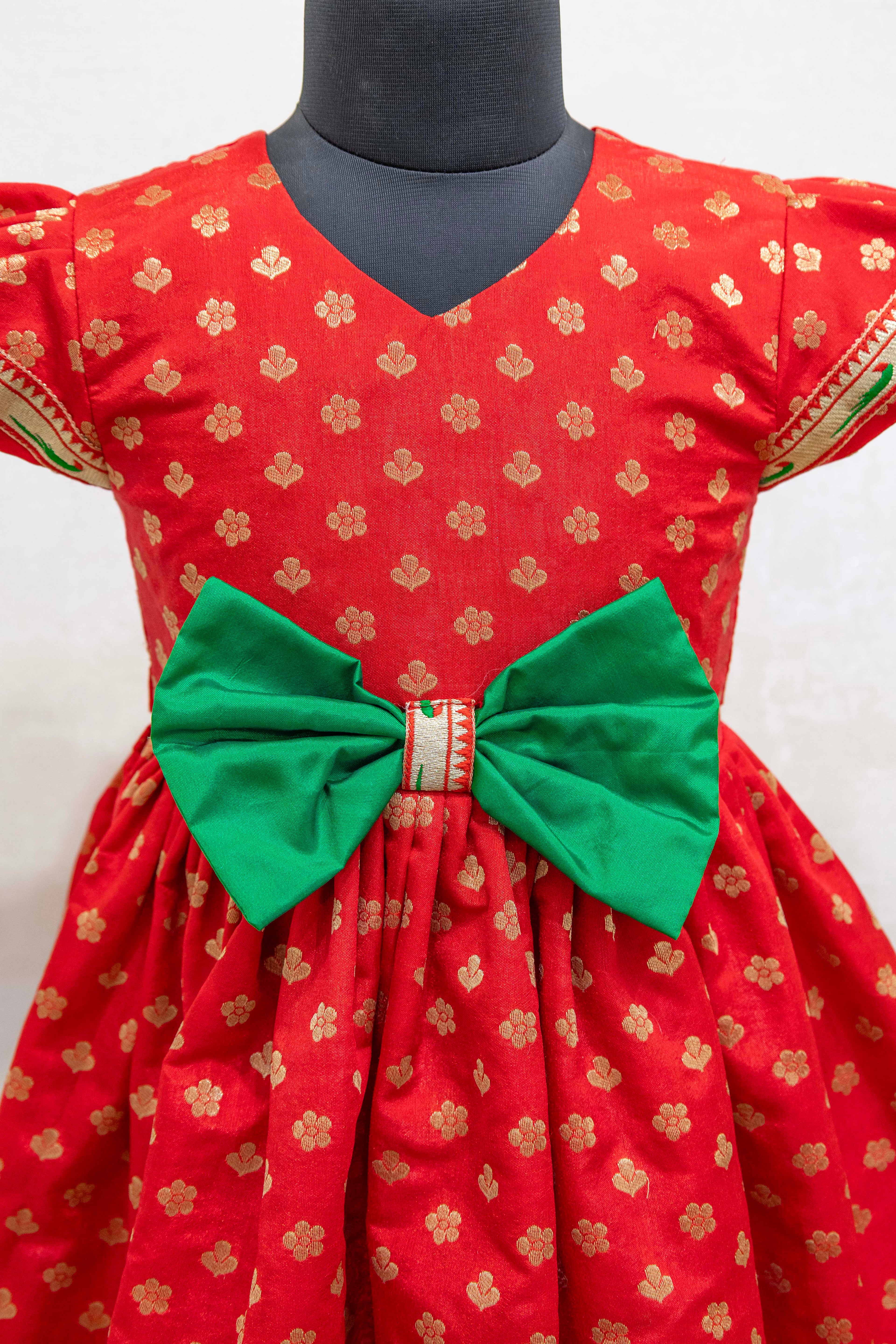 Red brocade silk flared dress with puffed sleeves and contrast Green bow at the waistline for Girls