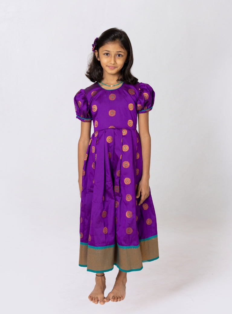 Purple jacquard brocade silk midi dress with broad paithani border for Girls.Let your princess be as comfortable as in her casuals with carefully designed and crafted Comfort Ethnic Wear by Soyara Ethnics. Keep her fashion quotient high with timeless patterns, vibrant combinations and royal textiles.
