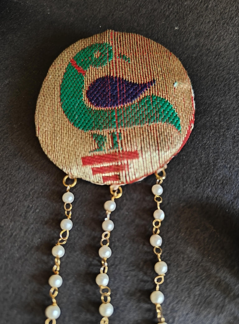 Handcrafted Parrot Paithani Brooch embellished with pearls and pearls strings.Perfect accessory for boys kurta. Mundavalya,kanthi,bhikbali,topi,pagdi are boys accessories exclusively designed using Pearls,glass beads,jadau & gold plated findings for Batu,for Upanayan/Vratabandha/munj /thread ceremony.