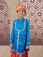 This teal blue raw silk kurta features a detailed yoke design highlighted by intricate all-over zari embroidery. It is elegantly finished with stone-studded buttons for a refined touch.