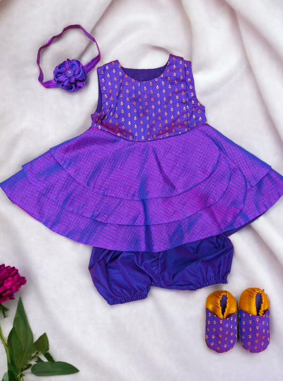 Purple front open layered dress with coordinated bloomer , headband and booties for a newborn baby girl.
