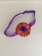 Purple paithani fabric flower elasticated headband for baby girl.