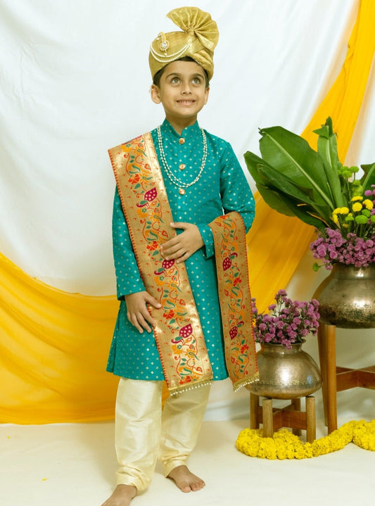 Emerald green brocade silk stand collar kurta with a cotton silk salwar and Paithani Shela.Kurtas with collar or Angrakha pattern teamed with salwar are the best choice for any festive occasion for boys. They are Trendy, Easy to wear and comfortable to carry.