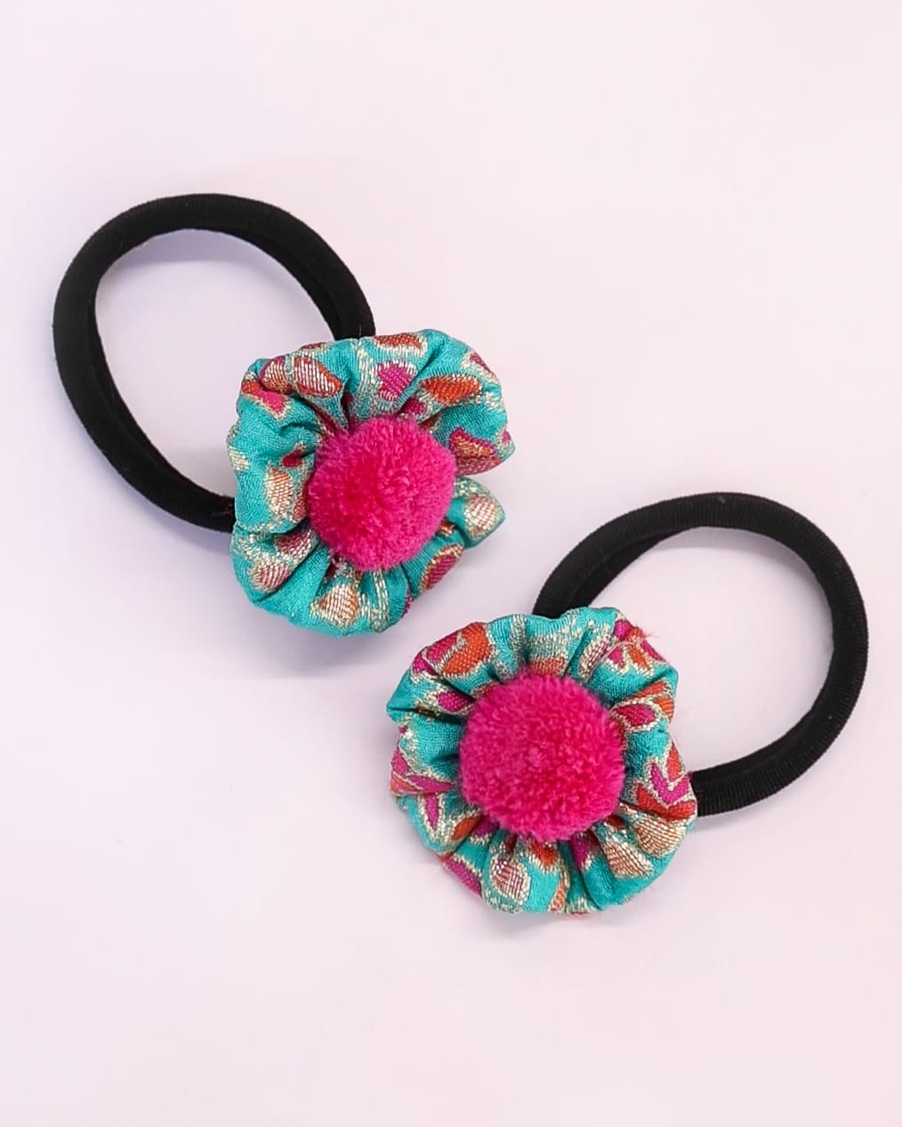 Set of two rubber bands with Turquoise Banaras Silk handmade flower embellished with woolen pompom for Girls