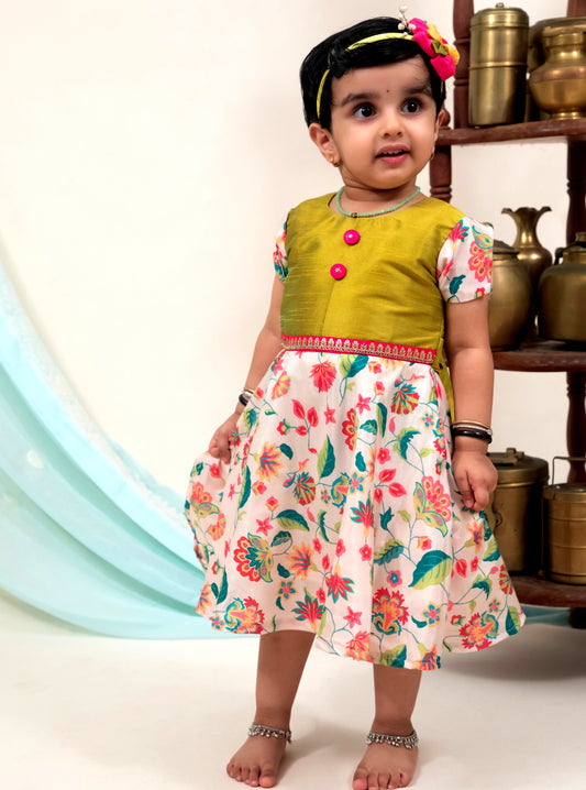 Ivory Printed Modal Silk Frock with Parrot Green Bodice for Girls.Let your princess be as comfortable as in her casuals with carefully designed & crafted Comfort Ethnic Wear by Soyara Ethnics.Keep her fashion quotient high with timeless patterns, vibrant combinations and royal textiles.