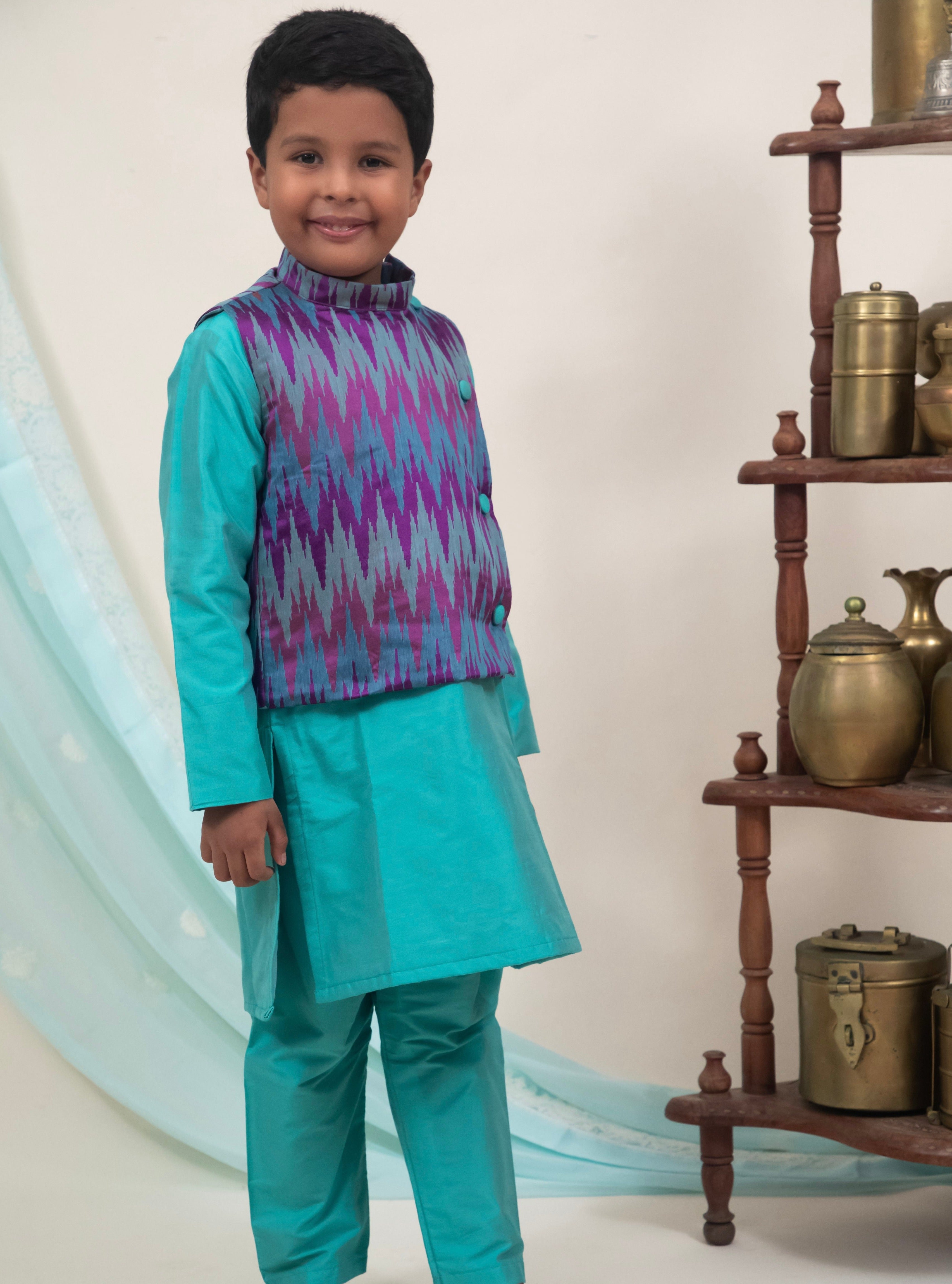 Cyan coloured cotton silk salwar kurta set with embossed patola jacket for Boys.Kurtas with collar or Angrakha pattern teamed with salwar are the best choice for any festive occasion for boys. They are Trendy, Easy to wear and comfortable to carry.    