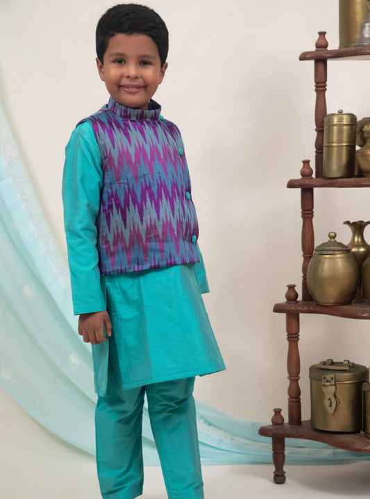 Cyan coloured cotton silk salwar kurta set with embossed patola jacket for Boys.Kurtas with collar or Angrakha pattern teamed with salwar are the best choice for any festive occasion for boys. They are Trendy, Easy to wear and comfortable to carry.    
