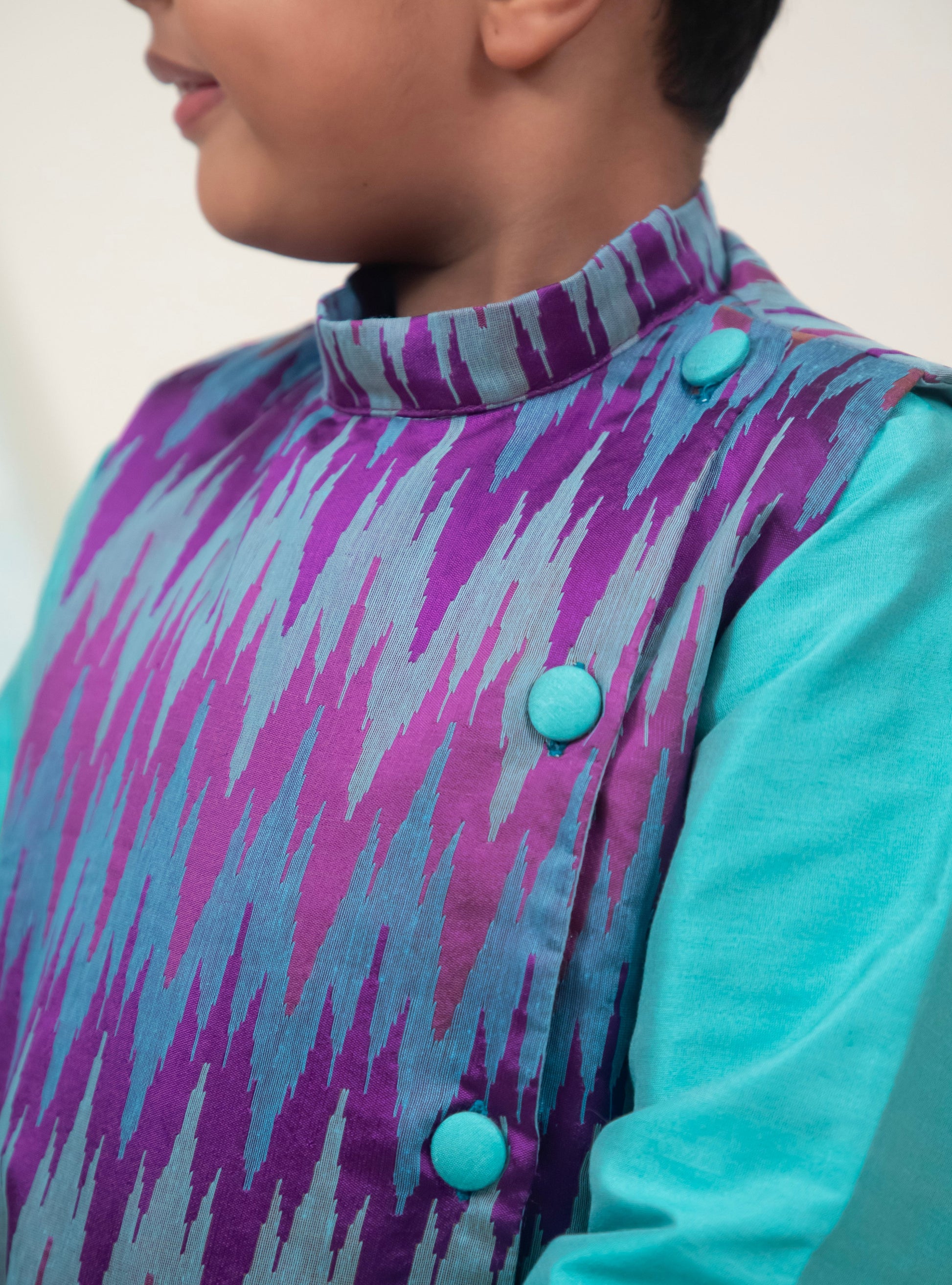 Cyan coloured cotton silk salwar kurta set with embossed patola jacket for Boys.Kurtas with collar or Angrakha pattern teamed with salwar are the best choice for any festive occasion for boys. They are Trendy, Easy to wear and comfortable to carry.    
