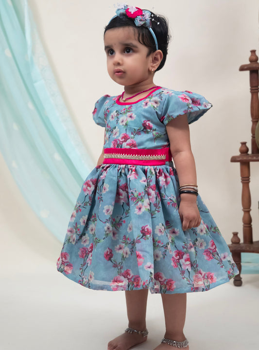 Grey Floral Chanderi Flared Dress With a dainty lace pattern at waist for Girl.Let your princess be as comfortable as in her casuals with carefully designed & crafted Comfort Ethnic Wear by Soyara Ethnics.Keep her fashion quotient high with timeless patterns, vibrant combinations and royal textiles.