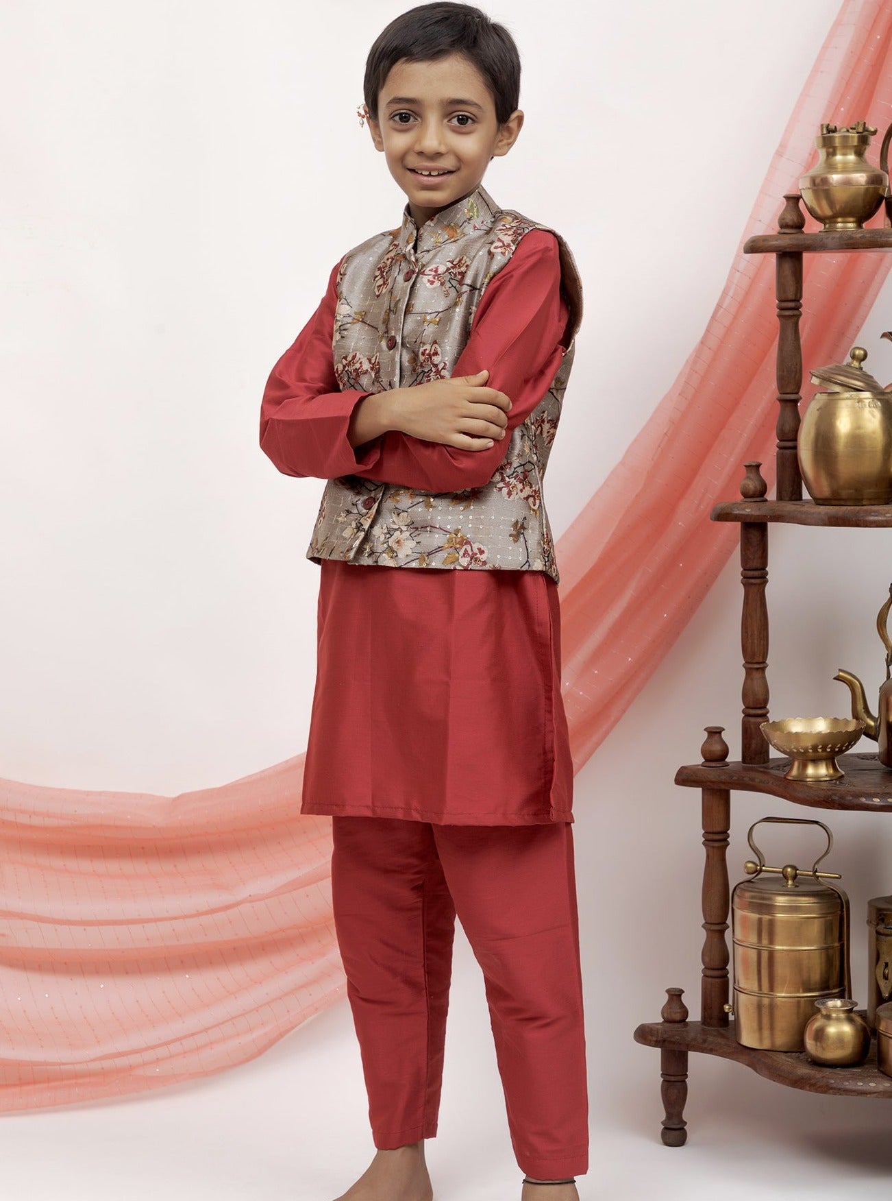 Maroon cotton silk salwar kurta set with grey printed tussar silk jacket.Kurtas with collar or Angrakha pattern teamed with salwar are the best choice for any festive occasion for boys. They are Trendy, Easy to wear and comfortable to carry.