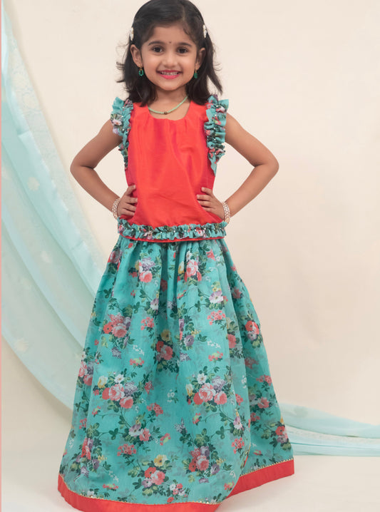 Cyan coloured floral printed chanderi ghagra with ruffled sleeved raw silk orange choli for girls.Let your princess be as comfortable as in her casuals with carefully designed & crafted Comfort Ethnic Wear by Soyara Ethnics.Keep her fashion quotient high with timeless patterns, vibrant combinations and royal textiles.