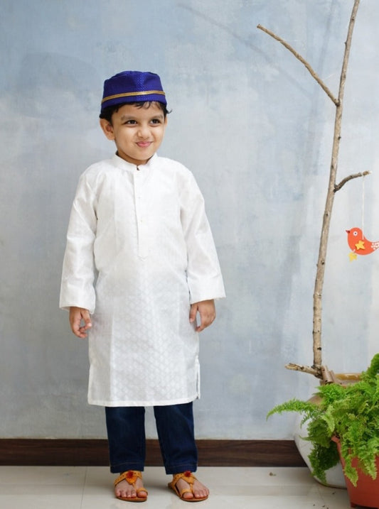 Emboss Silk White colored Stand Color Kurta.Kurtas with collar or Angrakha pattern teamed with salwar are the best choice for any festive occasion for boys.They are Trendy, Easy to wear and comfortable to carry.