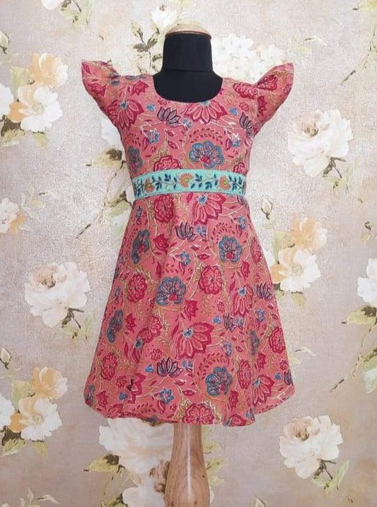 Blush Pink Sanganeri hand block print Semi Umbrella frock with puff sleeves.Let your princess be as comfortable as in her casuals with carefully designed & crafted Comfort Ethnic Wear by Soyara Ethnics.Keep her fashion quotient high with timeless patterns, vibrant combinations and royal textiles.