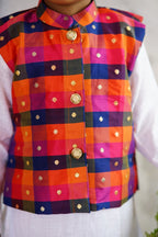 Vibrant Multi coloured Stand Collar Taffeta Silk Jacket.Cotton lining from inside avoid sweating but give warmth.Statement embellished buttons add royal charm to these jackets. Team these with any plain colored kurta or satin shirt for best festive look! 