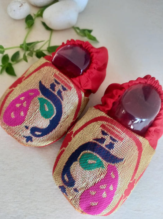 Paithani motif unisex booties for baby. Team these with any ethnic dress and complete the royal look! Completely made out of fabrics inside out , make these booties perfectly comfy first ethnic wear for the newborn. Quilted soal gives perfect grip to baby feet. 