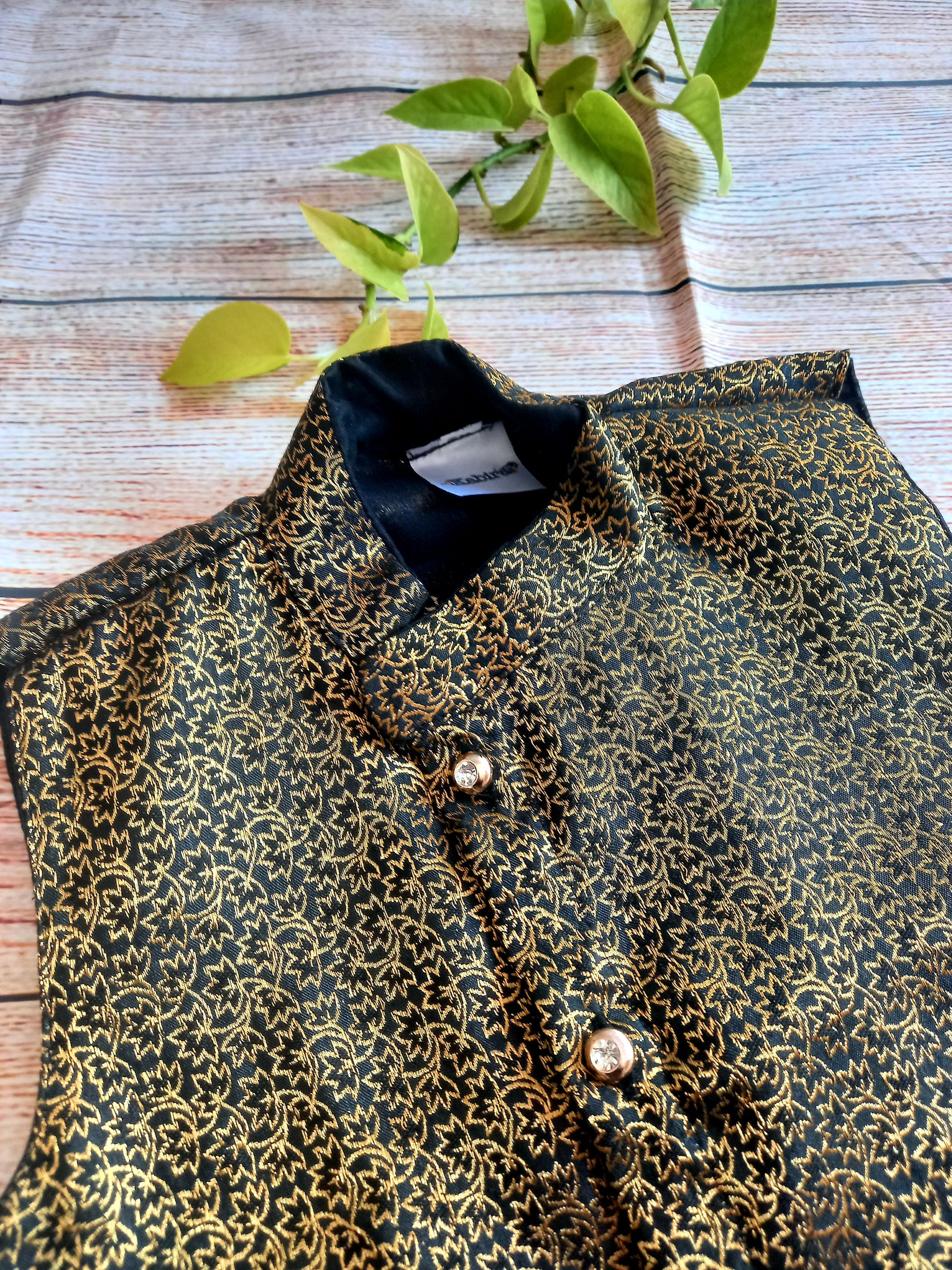 Black brocade stand collar Jacket.Cotton lining from inside avoid sweating but give warmth.Statement embellished buttons add royal charm to these jackets. Team these with any plain colored kurta or satin shirt for best festive look!