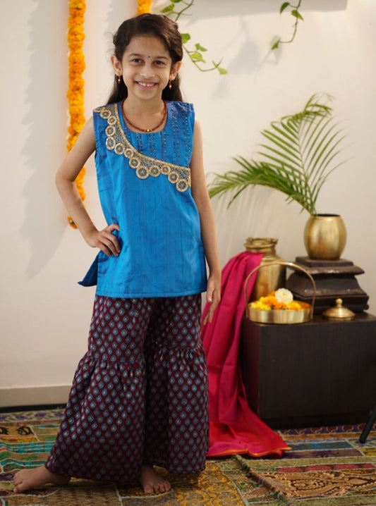 Brocade chanderi coffee brown sharara pants with peacock blue pure raw silk tunic.Let your princess be as comfortable as in her casuals with carefully designed & crafted Comfort Ethnic Wear by Soyara Ethnics.Keep her fashion quotient high with timeless patterns, vibrant combinations and royal textiles.