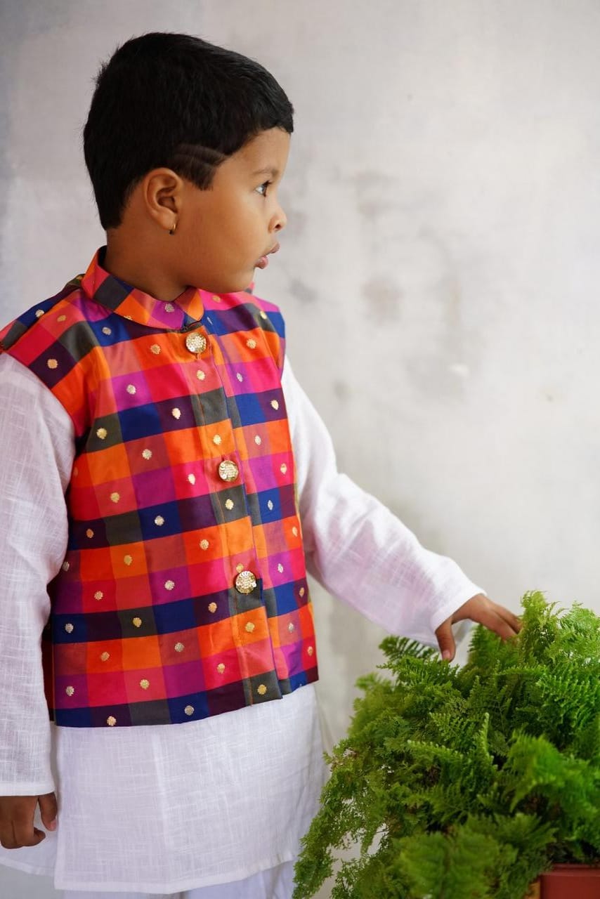 Vibrant Multi coloured Stand Collar Taffeta Silk Jacket.Cotton lining from inside avoid sweating but give warmth.Statement embellished buttons add royal charm to these jackets. Team these with any plain colored kurta or satin shirt for best festive look! 