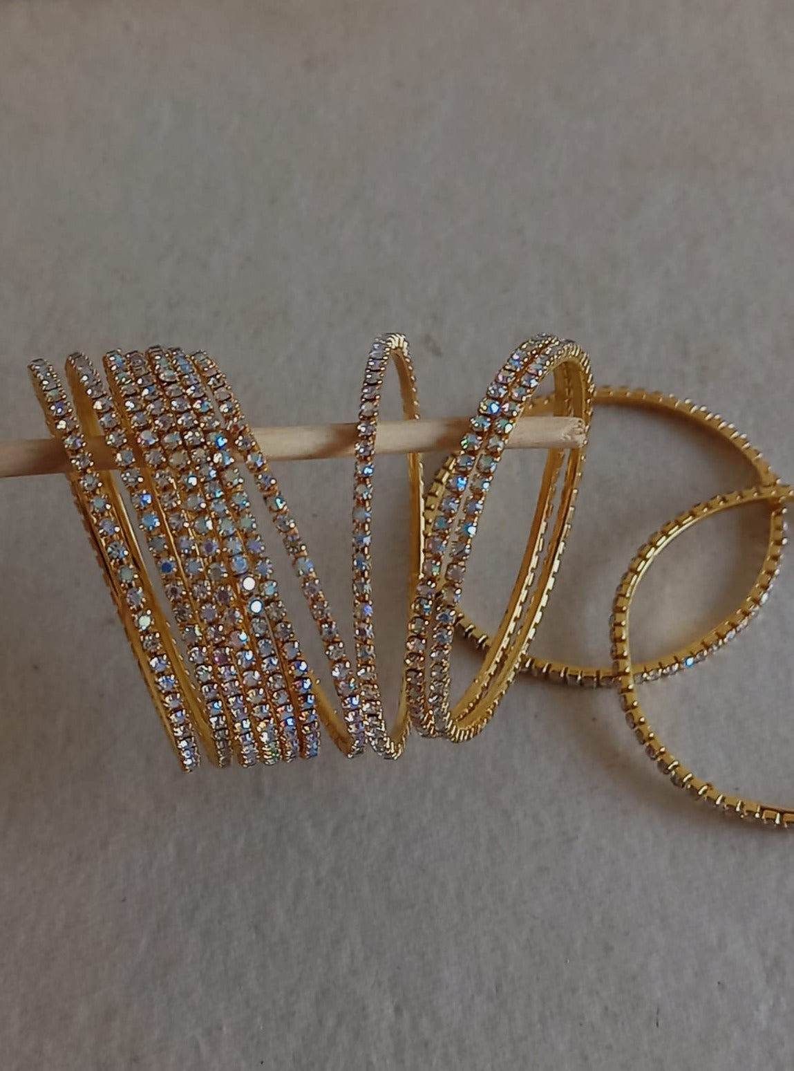 Stones bangles in white stones with rainbow shine Set of 12 for girls.Adorn your princess with head to toe premium quality handcrafted accessories made from allergy free, best quality materials.