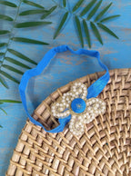 Pearl embellished stretchable Royal Blue headband for a baby. Golden brocade bonnet, paithani booties, cute fabric headbands all these Handcrafted accessories for Newborn are perfect add ons to any traditional attire of the baby. Designer baby mats, set of generic bloomers are the other naming ceremony essentials.