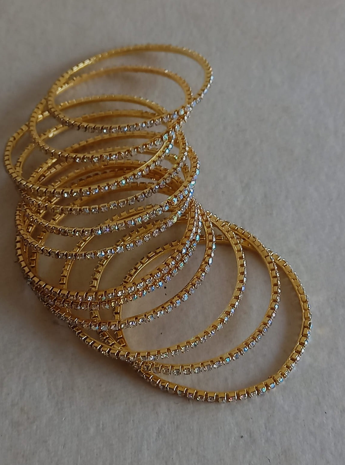 Stones bangles in white stones with rainbow shine Set of 12 for girls.Adorn your princess with head to toe premium quality handcrafted accessories made from allergy free, best quality materials.
