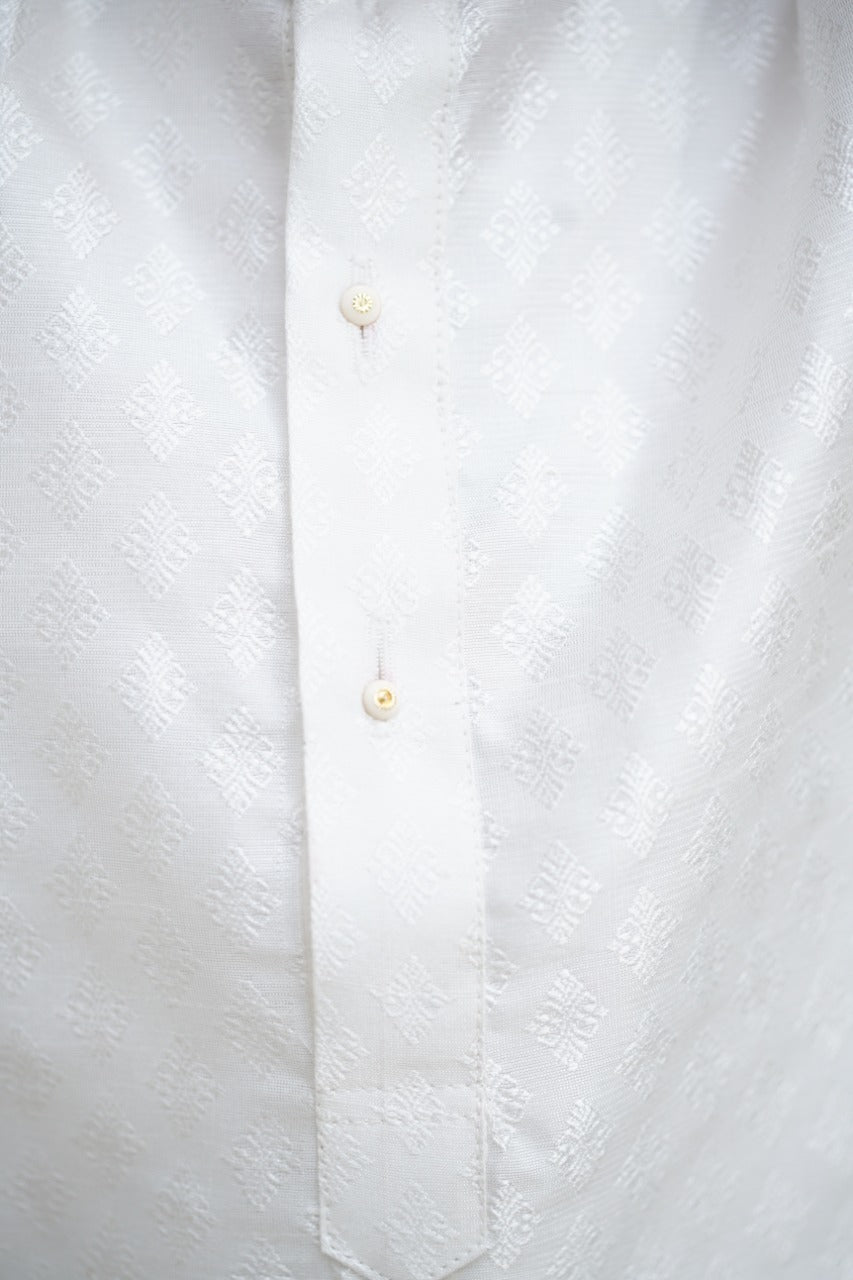 Emboss Silk White colored Stand Color Kurta.Kurtas with collar or Angrakha pattern teamed with salwar are the best choice for any festive occasion for boys.They are Trendy, Easy to wear and comfortable to carry.