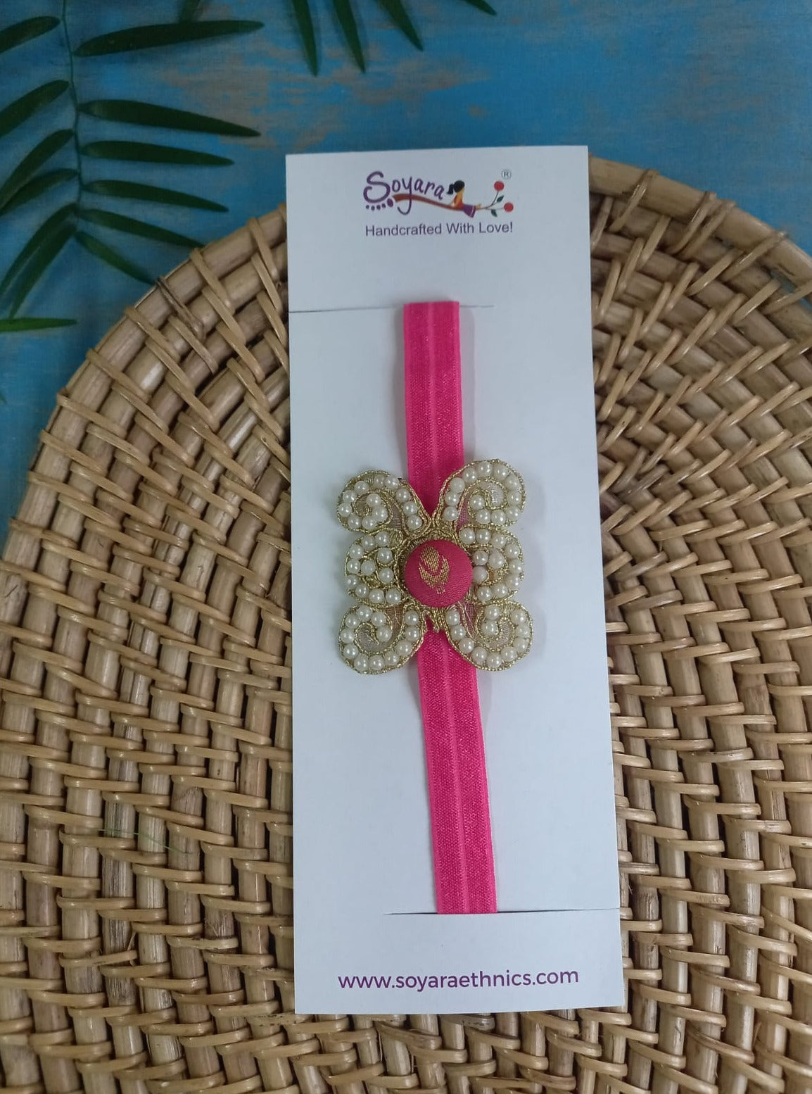 Pearl embellished stretchable Candy Pink headband for a baby. Golden brocade bonnet, paithani booties, cute fabric headbands all these Handcrafted accessories for Newborn are perfect add ons to any traditional attire of the baby. Designer baby mats, set of generic bloomers are the other naming ceremony essentials.