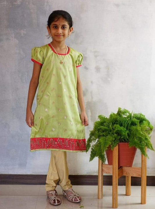 Fresh Lime Green Banarasi Silk Kurti with Delicate Flower Motifs.Let your princess be as comfortable as in her casuals with carefully designed & crafted Comfort Ethnic Wear by Soyara Ethnics.Keep her fashion quotient high with timeless patterns, vibrant combinations and royal textiles.