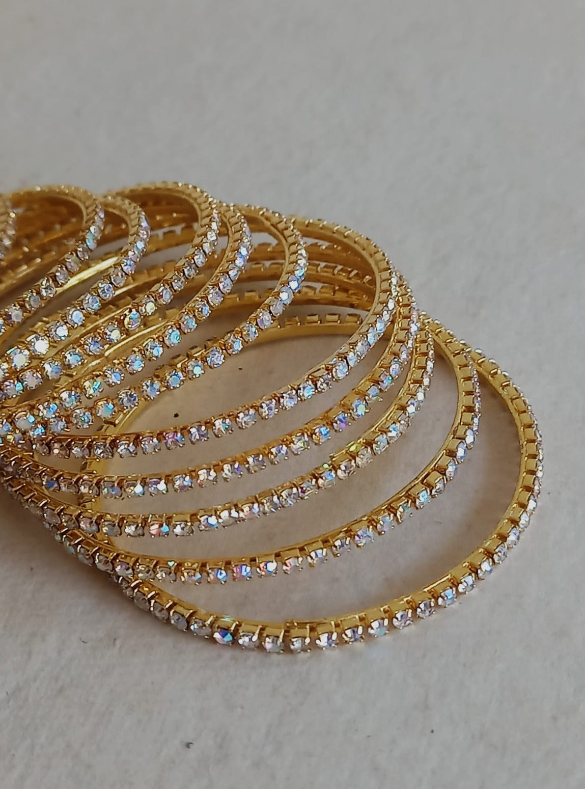 Stones bangles in white stones with rainbow shine Set of 12 for girls.Adorn your princess with head to toe premium quality handcrafted accessories made from allergy free, best quality materials.