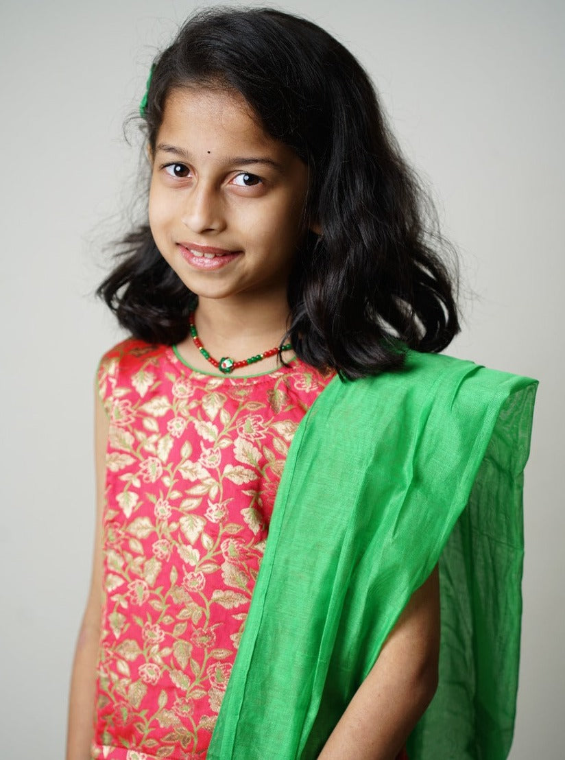 Parrot green chanderi ghagra with carrot pink brocade choli &  parrot green chanderi dupatta.Let your princess be as comfortable as in her casuals with carefully designed & crafted Comfort Ethnic Wear by Soyara Ethnics.Keep her fashion quotient high with timeless patterns, vibrant combinations and royal textiles. 