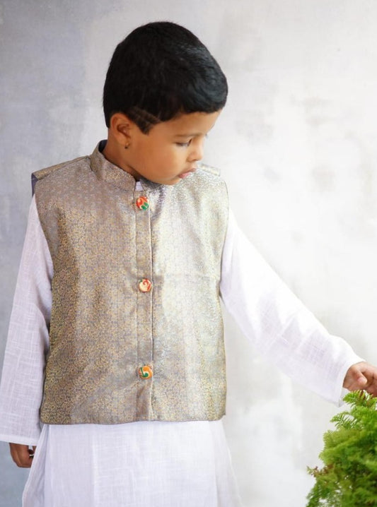 Grey coloured brocade silk stand collar jacket with statement brocade buttons.Cotton lining from inside avoid sweating but give warmth.Statement embellished buttons add royal charm to these jackets. Team these with any plain colored kurta or satin shirt for best festive look!