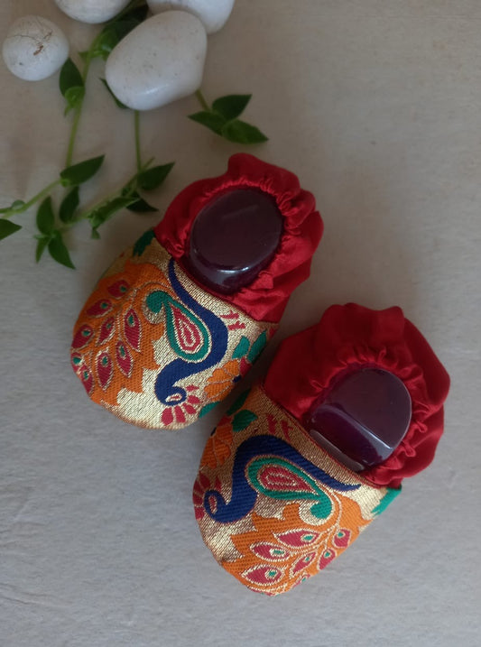 Paithani motif unisex booties for baby. Team these with any ethnic dress and complete the royal look! Completely made out of fabrics inside out , make these booties perfectly comfy first ethnic wear for the newborn. Quilted soal gives perfect grip to baby feet. 