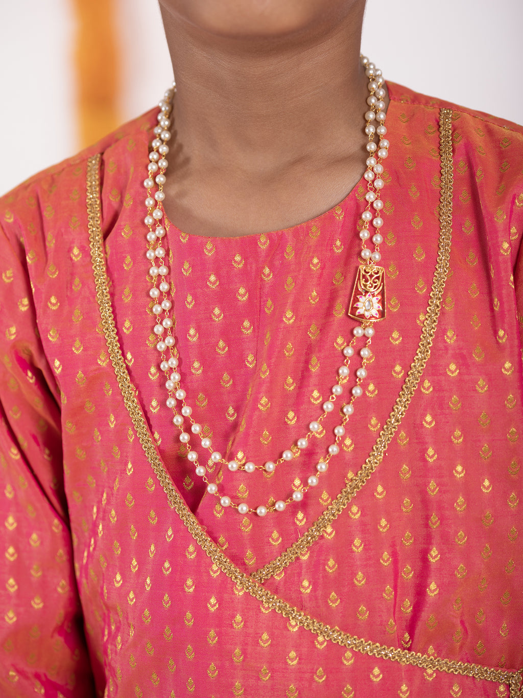 Carrot Pink intricate Butta brocade kurta with Angrakha pattern.Kurtas with collar or Angrakha pattern teamed with salwar are the best choice for any festive occasion for boys. They are Trendy, Easy to wear and comfortable to carry.