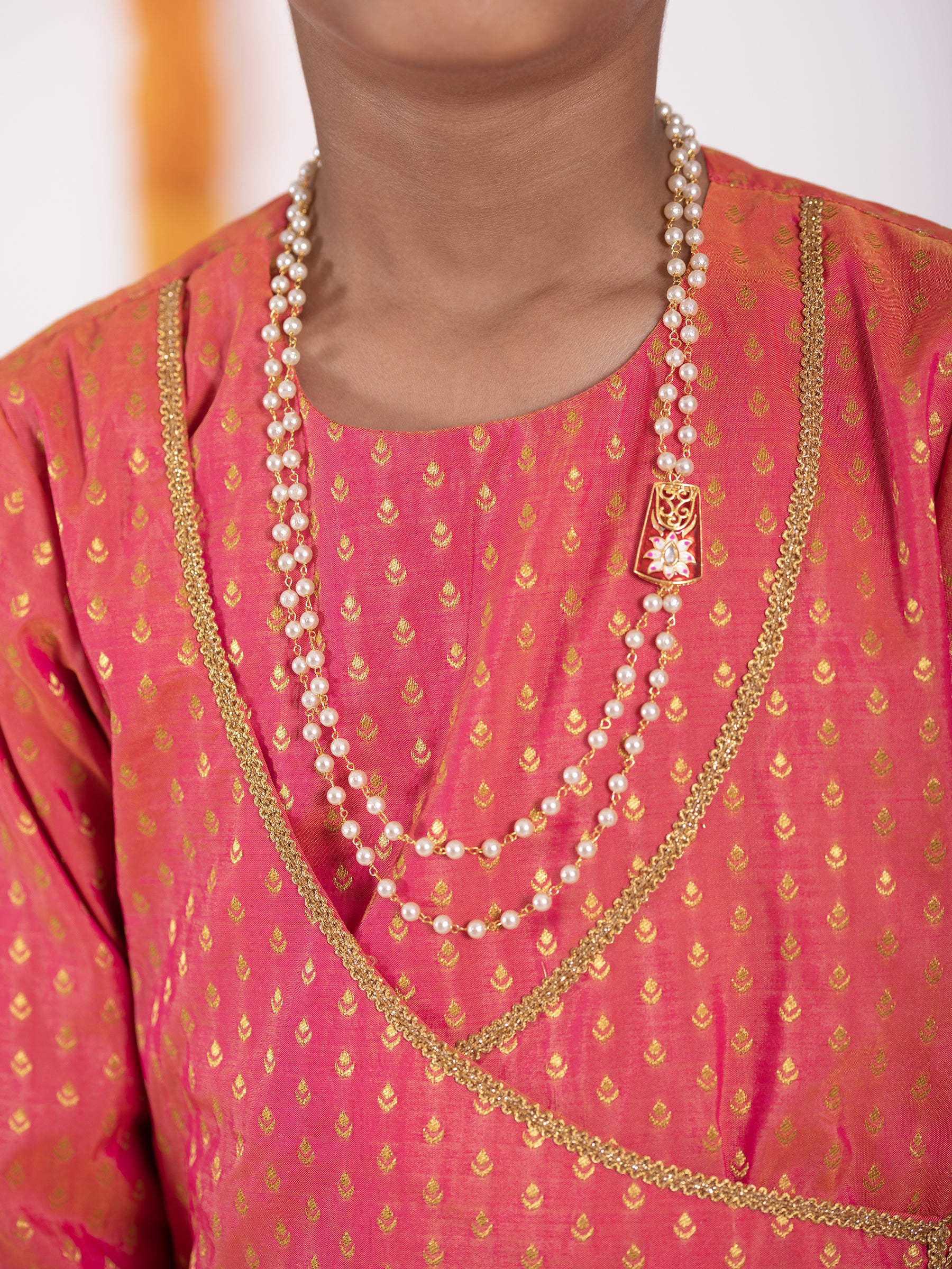 Carrot Pink intricate Butta brocade kurta with Angrakha pattern.Kurtas with collar or Angrakha pattern teamed with salwar are the best choice for any festive occasion for boys. They are Trendy, Easy to wear and comfortable to carry.