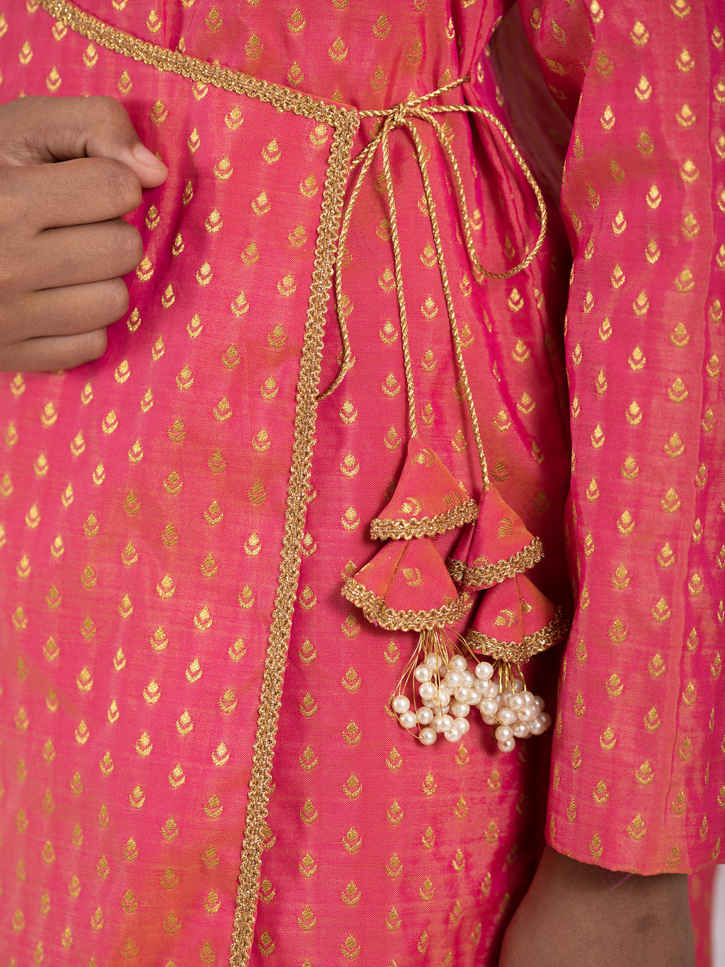 Carrot Pink intricate Butta brocade kurta with Angrakha pattern.Kurtas with collar or Angrakha pattern teamed with salwar are the best choice for any festive occasion for boys. They are Trendy, Easy to wear and comfortable to carry.