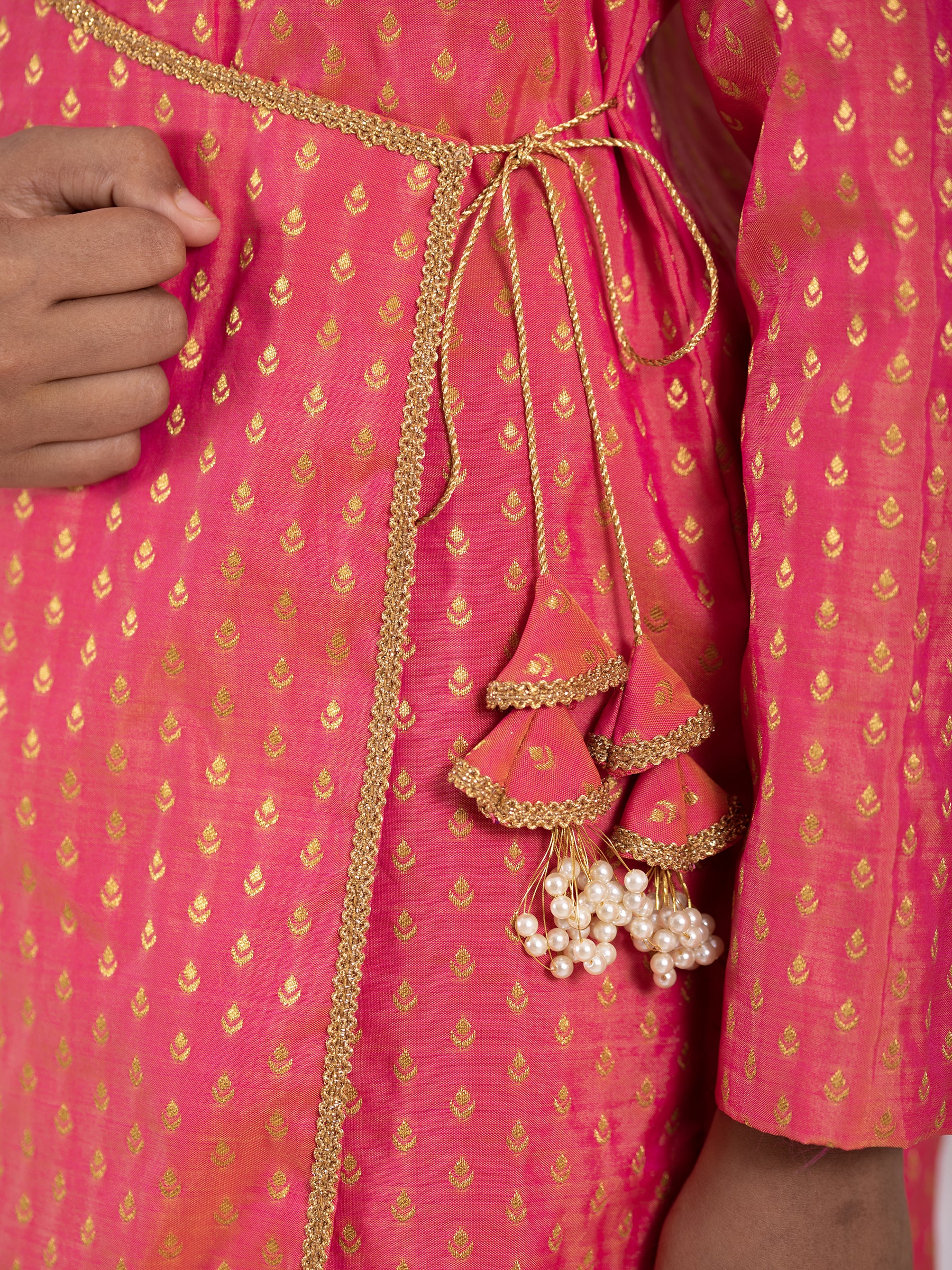 Carrot Pink intricate Butta brocade kurta with Angrakha pattern.Kurtas with collar or Angrakha pattern teamed with salwar are the best choice for any festive occasion for boys. They are Trendy, Easy to wear and comfortable to carry.