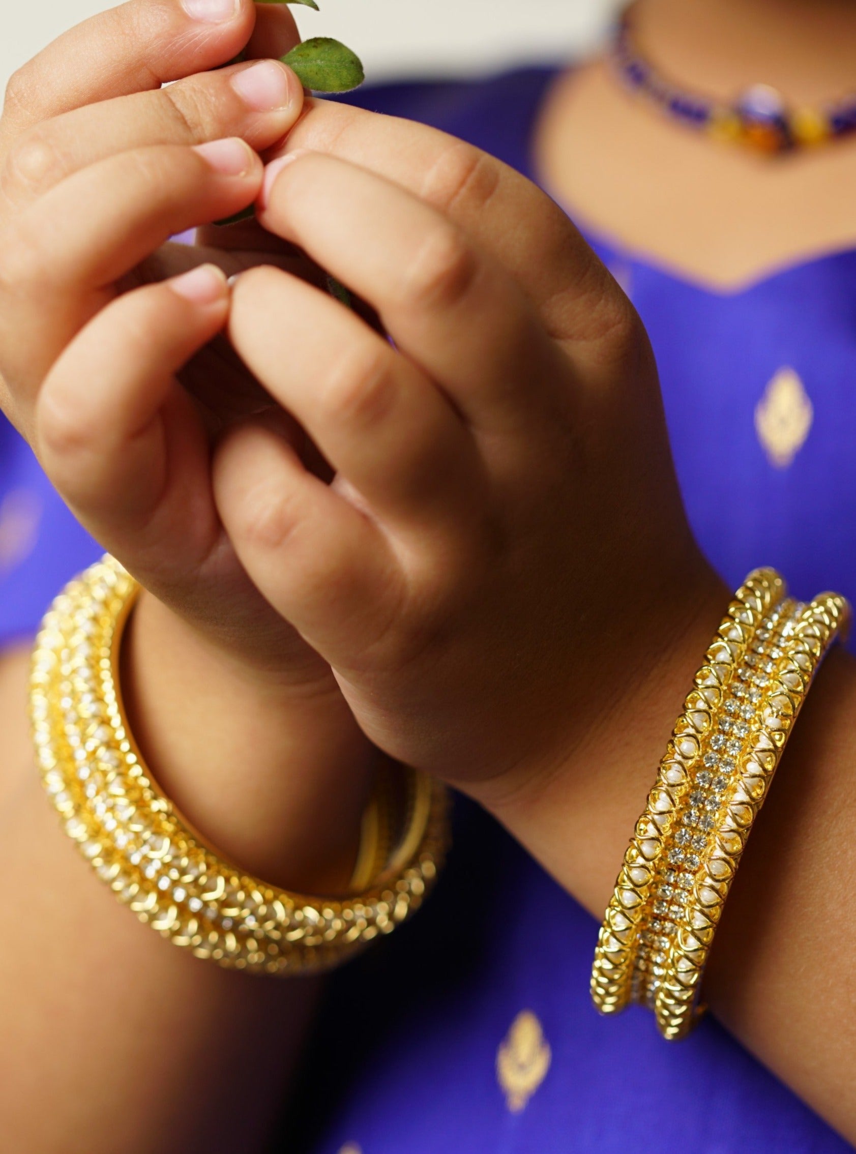 Three lined pearls and stones broad bangles Set of 2 for girls.Adorn your princess with head to toe premium quality handcrafted accessories made from allergy free, best quality materials.