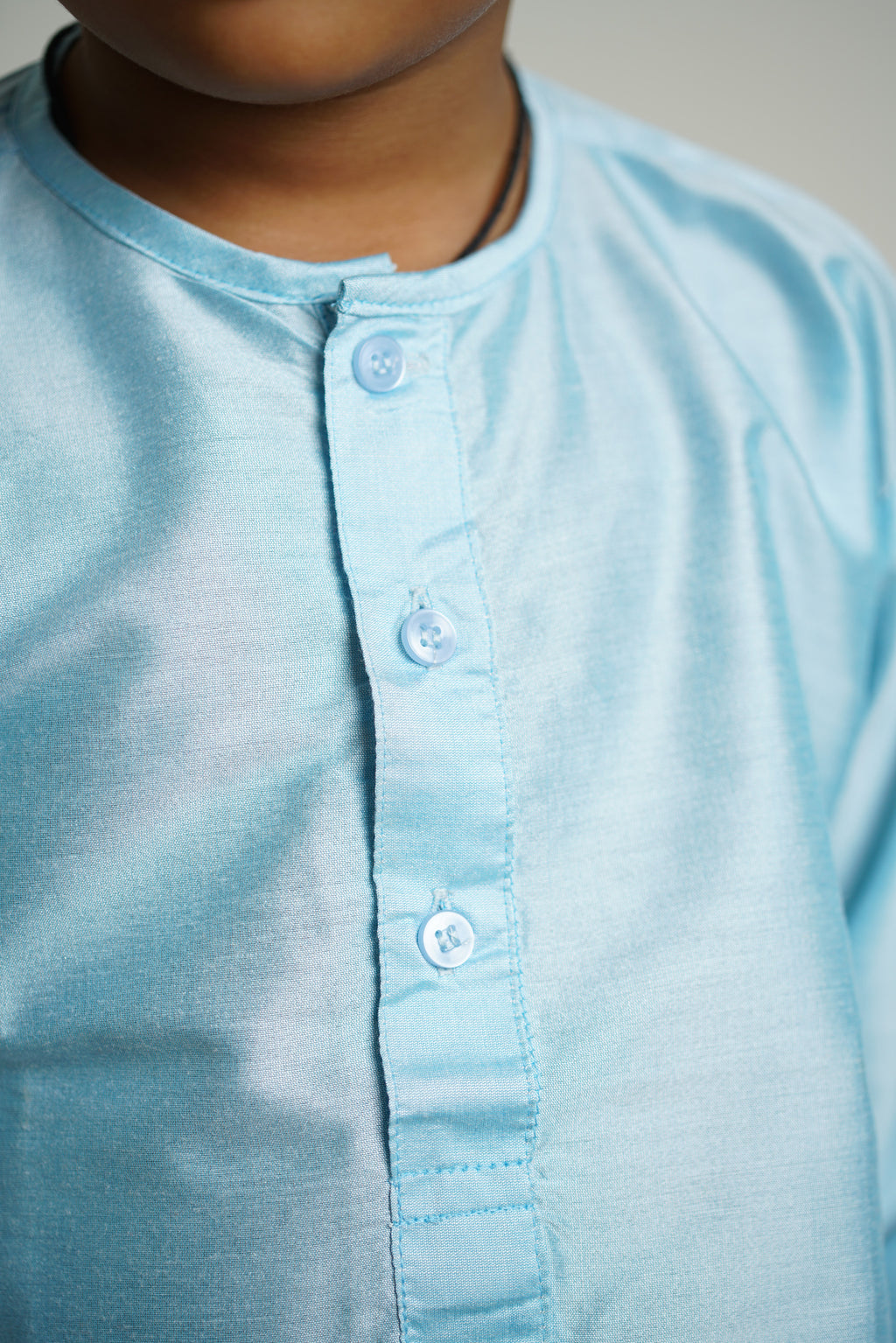 Light Sky Blue cotton silk Round neck long kurta with wooden buttons.Kurtas with collar or Angarakha pattern teamed with salwar are the best choice for any festive occasion for boys.They are Trendy, Easy to wear and comfortable to carry.