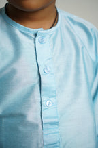 Light Sky Blue cotton silk Round neck long kurta with wooden buttons.Kurtas with collar or Angarakha pattern teamed with salwar are the best choice for any festive occasion for boys.They are Trendy, Easy to wear and comfortable to carry.