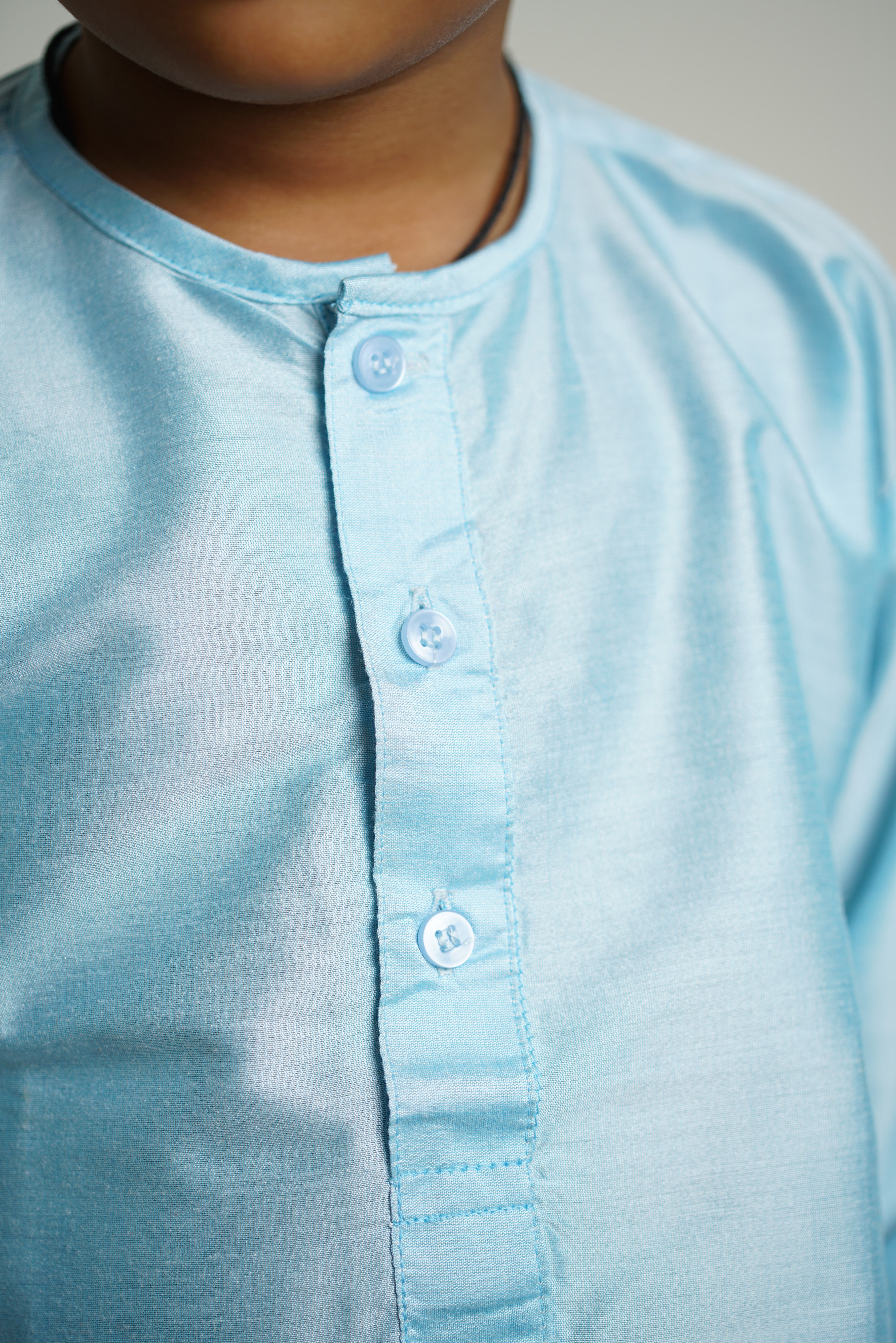 Light Sky Blue cotton silk Round neck long kurta with wooden buttons.Kurtas with collar or Angarakha pattern teamed with salwar are the best choice for any festive occasion for boys.They are Trendy, Easy to wear and comfortable to carry.
