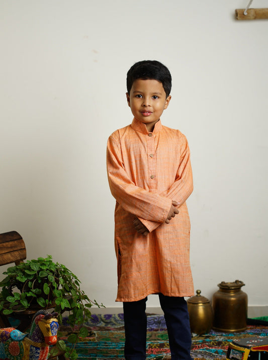 Light Orange Khadi silk stand collar long kurta with wooden buttons.Kurtas with collar or Angrakha pattern teamed with salwar are the best choice for any festive occasion for boys.They are Trendy, Easy to wear and comfortable to carry.