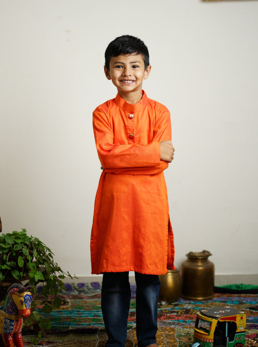 Orange cotton silk kurta with paithani fabric buttons.Kurtas with collar or Angrakha pattern teamed with salwar are the best choice for any festive occasion for boys.They are Trendy, Easy to wear and comfortable to carry.