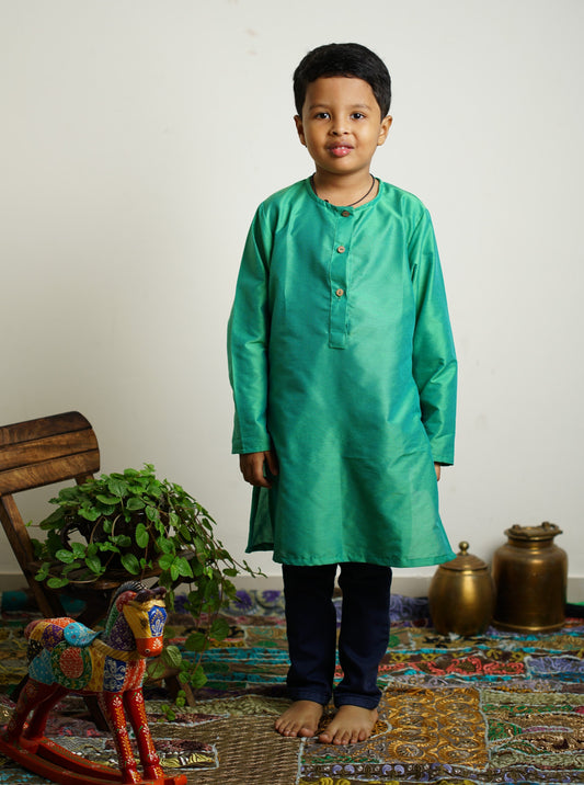 Emerald Green cotton silk Round neck long kurta with wooden buttons.Kurtas with collar or Angrakha pattern teamed with salwar are the best choice for any festive occasion for boys.They are Trendy, Easy to wear and comfortable to carry.