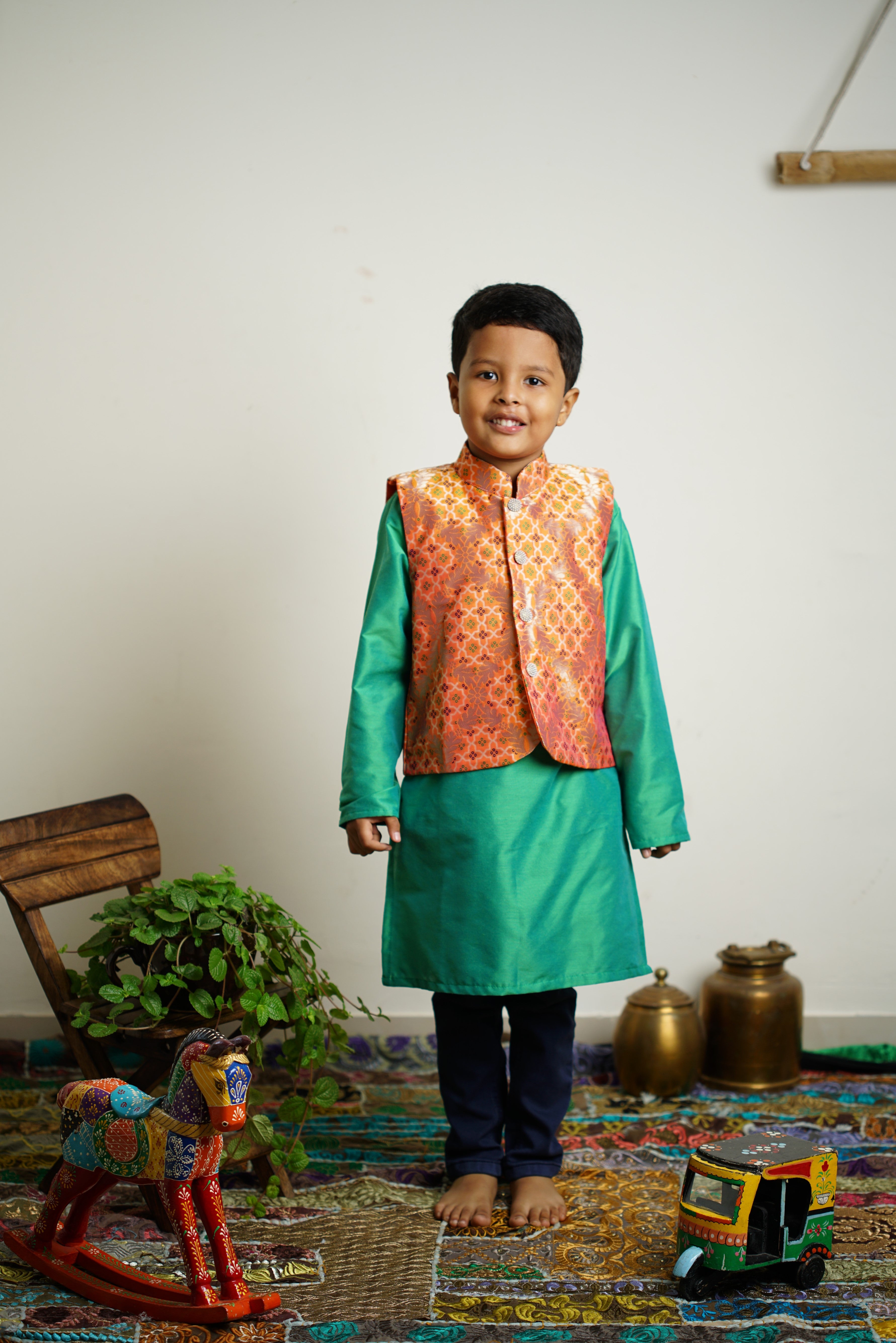 Light Orange Brocade jacket with multi color bandhani design .Cotton lining from inside avoid sweating but give warmth.Statement embellished buttons add royal charm to these jackets. Team these with any plain colored kurta or satin shirt for best festive look!