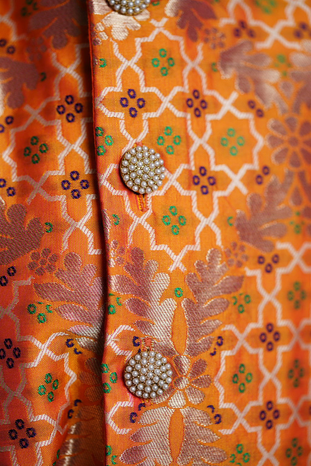 Light Orange Brocade jacket with multi color bandhani design .Cotton lining from inside avoid sweating but give warmth.Statement embellished buttons add royal charm to these jackets. Team these with any plain colored kurta or satin shirt for best festive look!